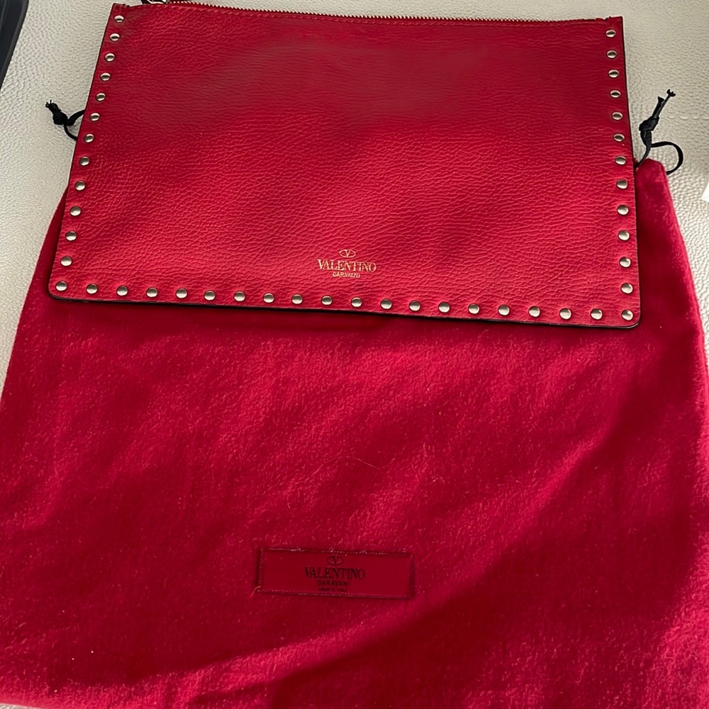 Valentino rock stud zip clutch. Great condition. Red color. Super stylish..